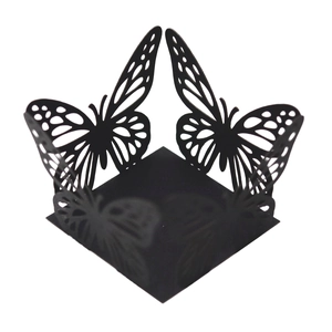 Detail of laser-cut black butterfly candy box holder with intricate hollow patterns