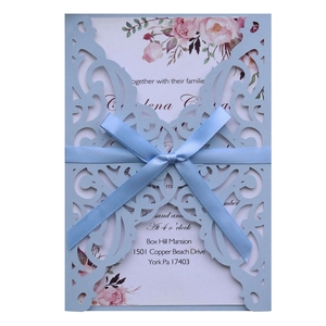 Laser cut light blue wedding invitation card with satin bow and watercolor floral insert