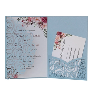 Laser-cut floral wedding invitation set with light blue lace cover and RSVP cards