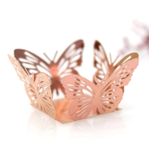 Close-up of laser-cut rose gold butterfly cupcake wrapper for wedding party decor