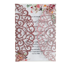 Detail of rose gold glitter wedding invitation with laser cut vine patterns and floral insert