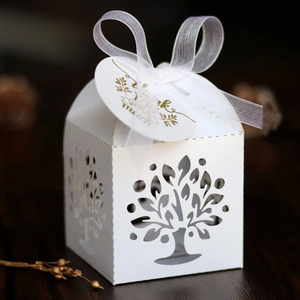 White laser-cut Tree of Life wedding favor box with a silk ribbon and Thank You tag