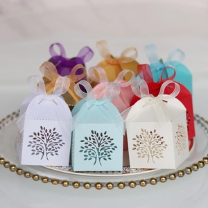 Detailed laser-cut tree design gift boxes in multiple colors with sheer ribbon bows