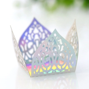Macro view of laser-cut iridescent paper cupcake wrapper with intricate hollow patterns