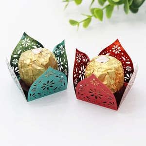 Laser-cut hollow chocolate wrapper decorations in metallic green, blue, and red colors