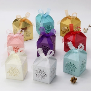 Detailed laser-cut tree design on colorful favor boxes with satin ribbon bow for parties