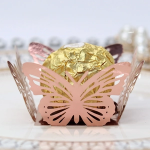 Close-up of rose gold hollow butterfly laser-cut chocolate wrapper for wedding party decor