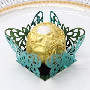 Detailed view of laser-cut butterfly chocolate wrapper in shiny turquoise paper