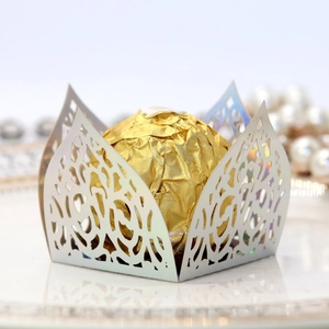 Macro view of laser-cut European lace chocolate box wrapper with pearl paper finish