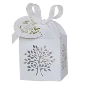 Detail of white laser-cut Tree of Life candy box with silk ribbon and Thank You tag