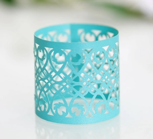 Detailed laser-cut heart and vine patterns on a turquoise pearl paper napkin ring