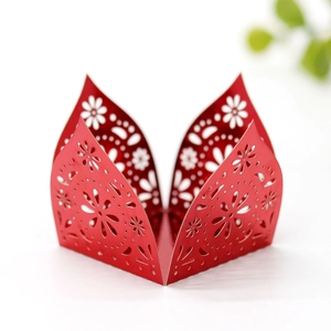 Detailed laser-cut plum blossom pattern on red cardstock candy box for wedding decor