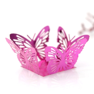 Detailed laser-cut butterfly cupcake wrapper in vibrant rose pink with lace patterns