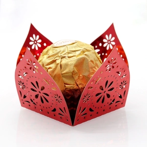 Detail of red laser-cut hollow candy wrapper with floral patterns for party decoration