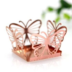 Detail of rose gold hollow butterfly candy box with laser-cut mirror reflection finish