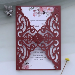 Detailed laser-cut burgundy wedding invitation with elegant hollow floral pattern design