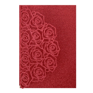 Macro detail of laser-cut red glitter rose pattern on cardstock wedding invitation