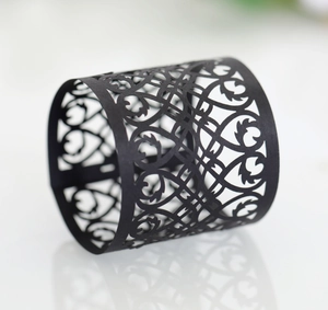 Detail showing black laser-cut hollow heart pattern napkin ring with elegant reflections