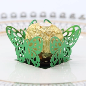 Detail of green laser-cut butterfly chocolate wrapper with intricate wing patterns