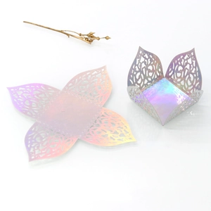 Holographic laser-cut candy box with intricate lace pattern shown flat and folded