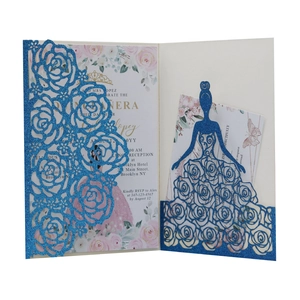 Detailed laser-cut blue glitter invitation featuring elegant floral and dress silhouettes