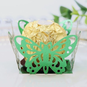 Macro detail of laser-cut green butterfly candy holder with pearlescent finish