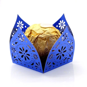 Macro detail of royal blue laser-cut candy holder with intricate floral patterns