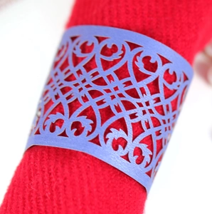 Close-up of purple laser-cut butterfly napkin rings with intricate floral lace patterns
