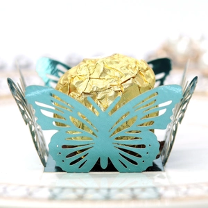 Detail of laser-cut lake blue butterfly paper candy holder for wedding party favors