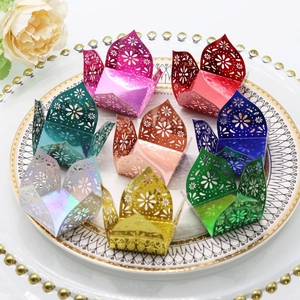 Laser-cut floral paper candy cups and truffle wrappers in various metallic colors