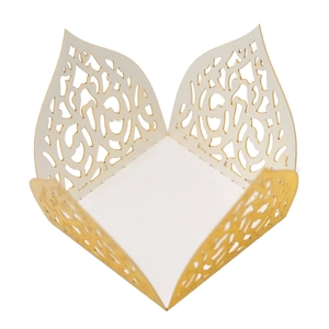 Macro detail of laser-cut paper candy box featuring elegant pearlescent floral hollow patterns