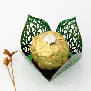 Detail of green laser-cut vine leaf chocolate wrap with delicate paper texture