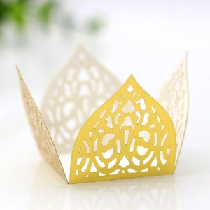 Detail of laser-cut hollow lace patterns on bright yellow paper cupcake wrappers