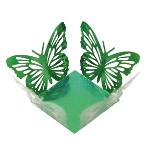 Macro detail of laser-cut green metallic paper candy box featuring 3D butterfly wings
