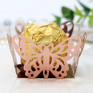 Macro detail of laser-cut pink butterfly chocolate holder for wedding party favors