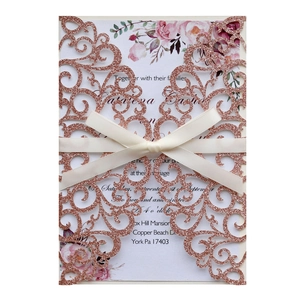 Laser cut rose gold glitter wedding invitation with ivory ribbon bow and floral insert