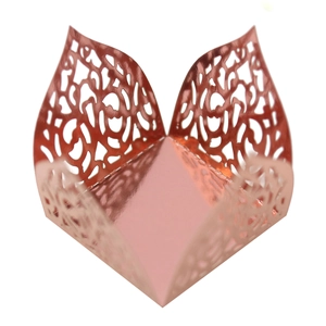 Detailed macro of laser-cut floral vine patterns on a rose gold mirror finish candy box