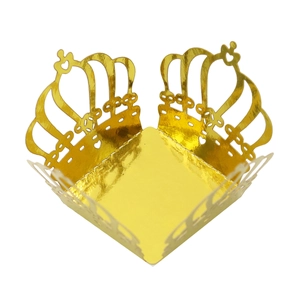 Macro view of laser-cut crown candy box in mirrored gold paper for party favors