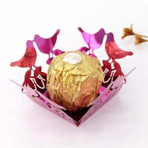 Macro view of laser-cut rose red bird design candy box with pearl paper texture