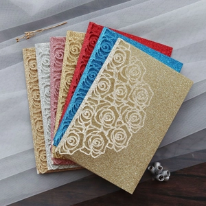 Detail of glitter laser cut rose patterns on elegant wedding invitation card covers