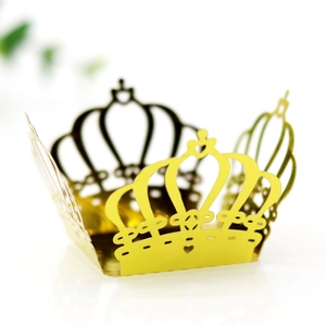 Macro view of laser-cut gold crown candy box with intricate hollowed patterns