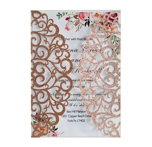 Detail of rose gold glitter wedding invitation with laser cut floral cover and insert