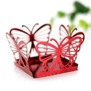 Macro detail of laser-cut butterfly hollow pattern on red mirror-finish wedding favor box