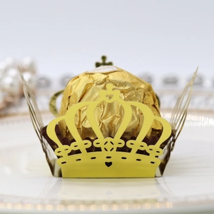 Macro view of gold laser-cut crown candy box with mirror finish and chocolate detail
