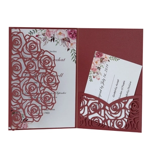 Detail of burgundy laser-cut rose wedding invitation set with floral inner card