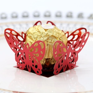 Macro view of a laser-cut red butterfly chocolate holder with intricate hollow details