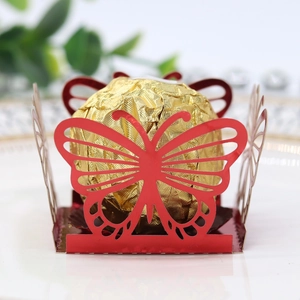Macro view of laser-cut red butterfly chocolate holder with detailed wing texture
