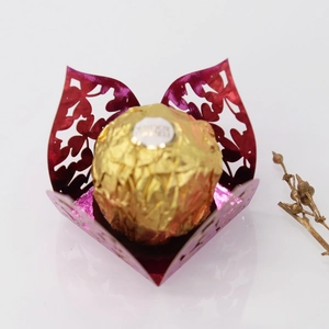 Macro view of metallic rose red hollow clover candy box with laser cut leaf patterns