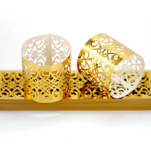 Golden cutout vine and heart pattern napkin rings for elegant wedding table settings