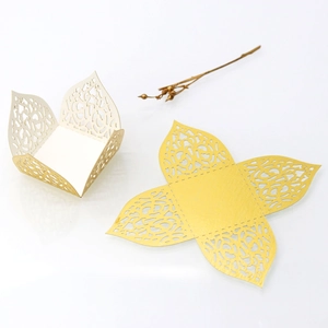 Laser-cut floral candy box with gold liner shown in flat and assembled forms